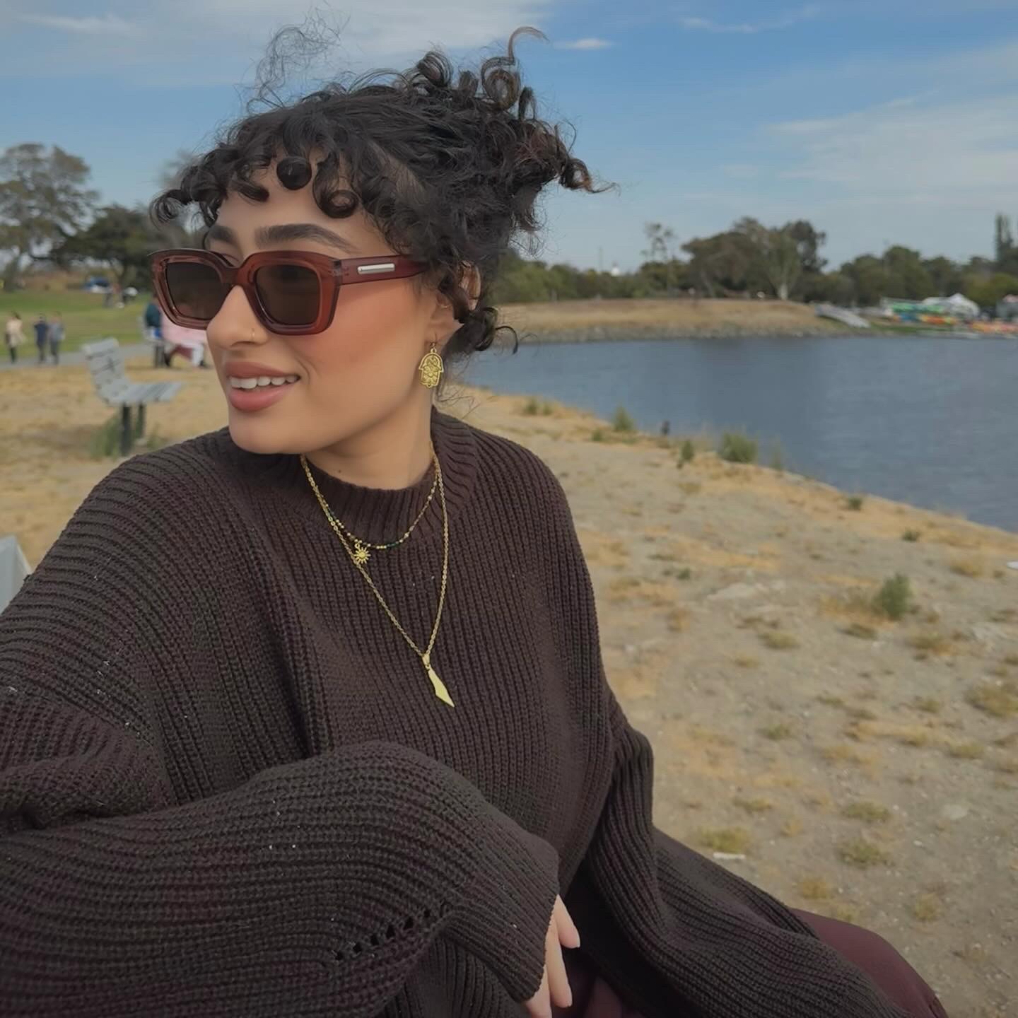 Katia wearing sunglasses beside a lake